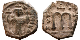 Constans II (641-668) Follis. Obverse: Imperial figure holding cross and globus Reverse: m and inscription

16mm 2,88g

Artificial sand patina