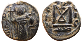 al-Malik ibn Marwan (687-705), Byzantine style folis Obverse: Imperial figure holding globe and cross Reverse: M and inscription

18mm 3,46g