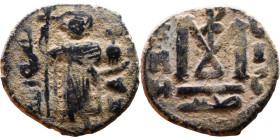 al-Malik ibn Marwan (687-705), Byzantine style folis Obverse: Imperial figure holding globe and cross Reverse: M and inscription

19mm 3,90g