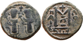 al-Malik ibn Marwan (687-705), Byzantine style folis Obverse: Two standing figures Reverse: Large M and inscription

19mm 4,11g
