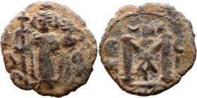 al-Malik ibn Marwan (687-705), Byzantine style folis Obverse: Imperial figure holding globe and cross Reverse: M and inscription

20mm 3,00g
