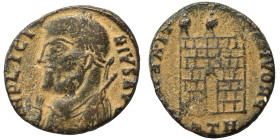 Licinius I, 308-324. Follis (bronze, 2.95 g, 17 mm). Laureate bust left, wearing imperial mantle, holding globe, sceptre and mappa. Rev. Camp gate sur...