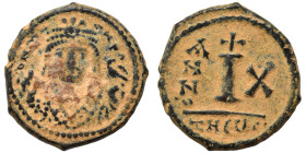 Maurice Tiberius. 582-602. Decanummium (bronze, 3.76 g, 18 mm), Theoupolis (Antioch). Helmeted and cuirassed bust facing, holding cross on globe in ri...