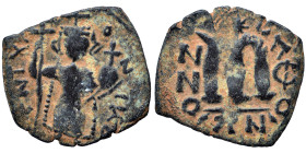 Constans II, 641-668. Follis (bronze, 2.18 g, 22 mm). Standing imperial figure holding long cross and globus cruciger. Rev. Large m; legend around. Ne...