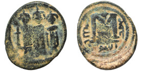Umayyad Caliphate. AH 41-60 / AD 661-680. Fals (bronze, 3.30 g, 19 mm), Tabariyya (Tiberias). Three standing imperial figures. Rev. Large M; monogram ...