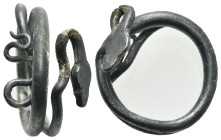 Roman silver ring in the shape of a coiled snake. Circa 3rd - 2nd centuries BC. (inner diam. 2.0 cm). Crystallized object, snake's head twisted and fr...