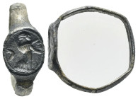Roman silver ring featuring a woman and a crescent (?). Circa 2nd century BC. (inner diam. 1.8 cm). Deformed and crystallized rod, with a surface crac...