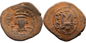 Heraclius (610-641) Follis. Obverse: Helmeted and cuirassed bust facing, holding globus cruciger and shield., Reverse: Large M above cross, ANNO

34...