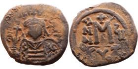 Maurice Tiberius (582-602) Follis. Obverse: Helmeted and cuirassed bust facing, holding globus cruciger and shield., Reverse: Large M above cross, ANN...