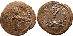 al-Malik ibn Marwan (687-705), Byzantine style folis Obverse: Imperial figure holding globe and cross Reverse: M and inscription

21mm 4,17g