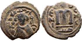 al-Malik ibn Marwan (687-705), Byzantine style folis Obverse: Imperial figure holding globe and cross Reverse: M and inscription

22mm 4.27g