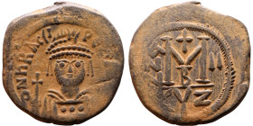 Heraclius (610-641) Follis. Obverse: Helmeted and cuirassed bust facing, holding globus cruciger and shield., Reverse: Large M above cross, ANNO

Ar...