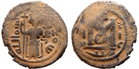 al-Malik ibn Marwan (687-705), Byzantine style folis Obverse: Imperial figure holding globe and cross Reverse: M and inscription

Artificial sand pa...