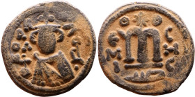 al-Malik ibn Marwan (687-705), Byzantine style folis Obverse: Imperial figure holding globe and cross Reverse: M and inscription

Artificial sand pa...