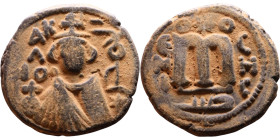 al-Malik ibn Marwan (687-705), Byzantine style folis Obverse: Imperial figure holding globe and cross Reverse: M and inscription

Artificial sand pa...
