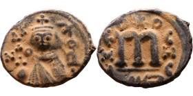 al-Malik ibn Marwan (687-705), Byzantine style folis Obverse: Imperial figure holding globe and cross Reverse: M and inscription

Artificial sand pa...