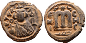al-Malik ibn Marwan (687-705), Byzantine style folis Obverse: Imperial figure holding globe and cross Reverse: M and inscription

Artificial sand pa...