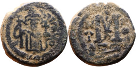 al-Malik ibn Marwan (687-705), Byzantine style folis Obverse: Imperial figure holding globe and cross Reverse: M and inscription

20mm 5.69g