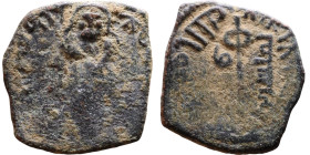 al-Malik ibn Marwan (687-705) Follis. Obverse: Standing caliph Reverse: Modified cross potent set on steps

17mm 1.97g