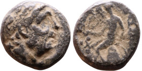 Antiochus II Theos (Seleukid King: 261-246 BC). AE bronze. Obv.: Diademed head of King Rev: Apollo seated left on omphalos, testing arrow and resting ...