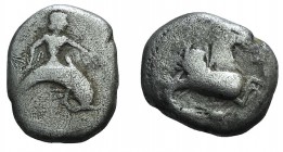 Southern Apulia, Tarentum, c. 500-480 BC. AR Nomos (18mm, 6.91g, 3h). Taras riding dolphin r., holding cuttle-fish in r. hand, l. hand extended. R/ Hi...