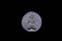 An Islamic Glass Roundel, uniface, in blue glass, depicting a kneeling female figure with one hand on her thigh and the other outstretched, border of ...