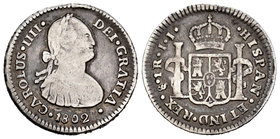 Carlos IV (1788-1808). 1 real. 1802. Santiago. JJ. (Cal-1209). Ag. 3,30 g. Único año de este ensayador. Muy escasa. BC+. Est...80,00.