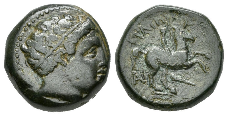 Imperio Macedonio. Filipo II. AE 18. 359-336 a.C. (Gc-6696). Anv.: Cabeza de Apo...
