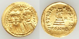 Heraclius (AD 610-641) and Heraclius Constantine. AV solidus (21mm, 4.46 gm, 8h). Choice XF, overstruck. Constantinople, 8th officina, AD 629-631. d d...