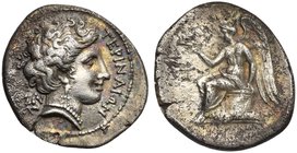 Bruttium, Terina, Drachm, ca. 300 BC
AR (g 2,34; mm 18; h 9)
TEPINAIΩN, female head r.; behind, triskeles, Rv. Winged Nike seated on cippus l., hold...