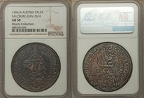 Salzburg. Johann Ernst Taler 1694 AU58 NGC, KM254, Dav-3510. Struck to the utmost precision, the surfaces toned to a glassy obsidian with emerald and ...