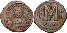 Justinian I (527-565). AE Follis, Constantinople mint. D/ DN IVSTINIANVS PP AVG. Helmeted and cuirassed bust facing, holding globus cruciger and shiel...