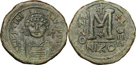 Justinian I (527-565). AE Follis, Nicomedia mint. D/ DN IVSTINIANVS PF AVG. Helmeted and cuirassed bust facing, holding globus cruciger and shield; to...