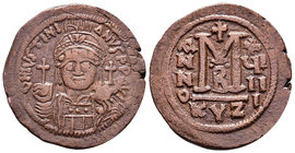 Justinian I, AE Follis. Cyzicus. 527-565 AD. DN IVSTINIANVS PP AVG, helmeted, cuirassed bust facing, holding cross on globe and shield with horseman m...