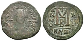 Justinian I, AE Follis. Cyzicus. 527-565 AD. DN IVSTINIANVS PP AVG, helmeted, cuirassed bust facing, holding cross on globe and shield with horseman m...