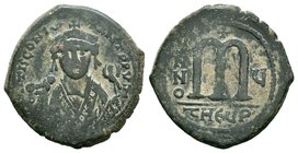 Tiberius II Constantine, AE follis, Antioch mint, 578-582 AD. Blundered legend, M TIC CONOSOV TONZITY PP TIV, crowned and cuirassed bust facing, cross...