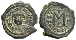 Maurice Tiberius, 582-602 AD, AE Follis. Constantinople. DN MAVRIC TIBER PP AVG, Helmeted and cuirassed bust facing, holding cross on globe and shield...