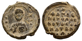 Lead seal of Katakalon (ca 11th cent.), Obverse: The bust of saint Nicholas en face, nimbate, wearing bishop garments and omophorion, holding in his l...