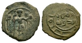 SALDUQIDS: Nasir al-Dawla Ghazi, 1132-1145, AE fals , NM, ND, standing figure holding long cross and diadem, with cornucopiae in background, possibly ...