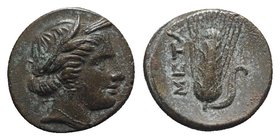 Southern Lucania, Metapontion, c. 300-250 BC. Æ (13mm, 2.80g, 6h). Wreathed head of Demeter r., wearing earring and necklace. R/ Grain ear with leaf t...