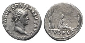 Vespasian (69-79). AR Denarius (17mm, 2.72g, 6h). “Judaea Capta” commemorative. Rome, 69-70. Laureate head r. R/ Trophy; to r., Judaea seated r. in at...