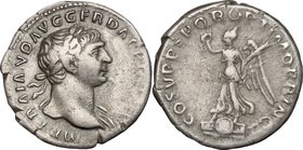 Trajan (98-117). AR Denarius, 103-111. D/ Bust right, laureate, draped on left shoulder. R/ Victory standing left on a round and an oblong shield, hol...
