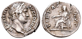 Adriano. Denario. 132 d.C. Roma. (Spink-3514). (Ric-690). (Seaby-1037a). Rev.: PIETAS AVG. Piedad sentada a izquierda con pátera y cetro. Ag. 3,23 g. ...