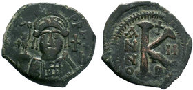 BYZANTINE.Justin II, 565 – 578 . AE Half follis. Antioch mint.DN YSTILI P P AYG Helmeted and cuirassed bust facing, holding globe surmounted by Victor...