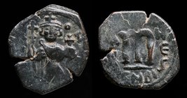 ARAB-BYZANTINE, Rashidun/Umayyad, AE fals, c. 650s-660s. 4.95g, 20-23mm.
Obv: Imperial figure standing facing, holding long cross and globus cruciger...