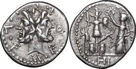 M. Furius L. f. Philus.AR Denarius, 119 BC.D/ Head of Janus, laureate.R/ Roma standing left, crowning trophy flanked by carnyx and shield on each side...