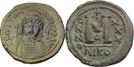 Justinian I (527-565).AE Follis, Nicomedia mint.D/ DN IVSTINIANVS PP AVG. Bust facing, helmeted, cuirassed, holding globus cruciger and shield.R/ Larg...