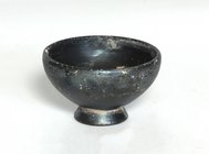 Greek black-glazed miniature cup.
 4th century BC.
 6,8 cm diameter; 4.5 cm high.