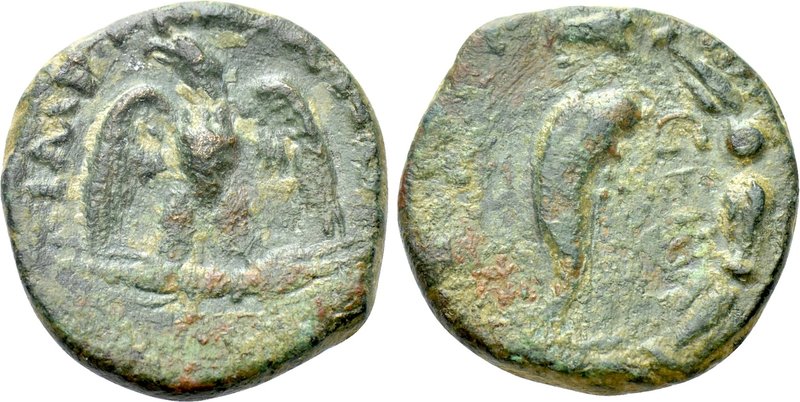 UNCERTAIN. Trajan (117-138). Ae. 

Obv: IMP TRAIANO / CAE. 
Eagle standing fa...