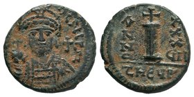 Justinian I, AE Decanummium, Antioch, AD 527-565. DN IVSTINIANVS PP AVG, helmeted, cuirassed bust facing, holding cross on globe and shield, cross to ...